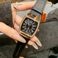 Detailed view of tonneau gold quartz watch featuring rhinestones and black leather strap - Rose Gold Black
