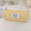 Macro view of yellow knitted stationery bag with tulip embroidery and metal zipper - Yellow