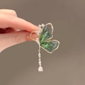 Close-up of green acrylic butterfly brooch with gold frame, rhinestones and pearl tassel - Green Butterfly Tassel