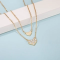 Elegant gold heart necklaces with crystal and matte finishes on a light blue backdrop - Gold Pavé and Matte Double Heart