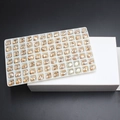 Oval champagne glass rhinestones for nail art displayed in a white storage tray - 7*9mm (42 Pcs) / Golden Shadow
