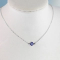 Silver thin chain necklace with a blue evil eye pendant on a white neck display model - Silver Link Chain Blue & White Evil Eye Pendant