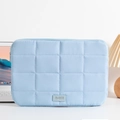 Close-up of light blue quilted laptop sleeve with minimalist texture and leather tag - 14" / Blue