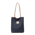 Blue denim tote bag with woven handles and white label patch on white background - Small / Dark Blue