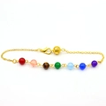 Detail of colorful beads on a gold chain with a hollow ball charm and lobster clasp - 7 Chakra Red Beads Gold Style / Gold