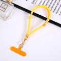 Macro shot of yellow braided phone lanyard with gold metal buckle and orange patch - Yellow