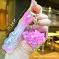 Detail of pink heart-shaped quicksand keychain with 45g weight and fairy tales strap - Pink Bow With Glowing Bubble Beads And Heart