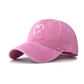 Detail of pink washed cotton baseball cap featuring a white heart embroidery and worn texture - Adjustable / Pink