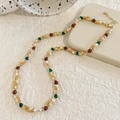 Detail of bohemian necklace with yellow shell beads, red stones, and white freshwater pearl - Multi-color Shell Style