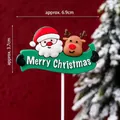 Merry Christmas cake topper with Santa and Reindeer design, 6.9cm width decoration - Soft Rubber Santa Holding Green Sign
