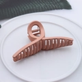 Matte pink plastic hair claw clip with cross design on white ceramic plate - Matte Cross Lotus Root Pink