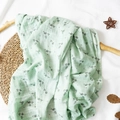 Mint green muslin baby blanket with gray floral print on textured white background - Mint Green Floral
