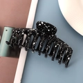 Macro detail of large black hair claw clip with white ink splash pattern and smooth resin finish - Glossy Black Splash Ink 11cm