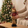 Detail of a plush Christmas dog doll with knitted sweater and hat in warm home setting - Extendable Dog (ML-Q778)