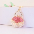 Golden handbag keychain with sparkling pink crystals and elegant white pearls - Pink