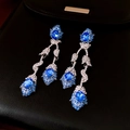 Detailed view of silver crane drop earrings with blue gems and crystals on black leather - 31# Silver Pin - Silver Blue Flower Leaf Tassel
