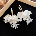 Detailed view of elegant white floral tassel earrings with pearls on black velvet tray - White-Big Flower (16# Silver Pin)