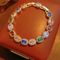 Detailed macro view of vintage oval colorful gemstone bracelet with cubic zirconia paving - Bracelet-Gold-Multicolor