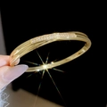 Macro detail of 18k gold plated bangle featuring a side row of sparkling square zircons - Gold-Side Pavé (7#)