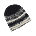 Close-up of black and white striped knit beanie with plush faux fur texture and brand tag - Black with White Stripes