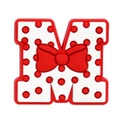 Macro shot of letter M PVC shoe charm with red polka dot pattern and bow detail - 13-Polka Dot Bowtie Letter M