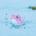 Miniature purple and white dolphin figurine on blue sand with size markings - No. 18 Dolphin