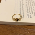 Close-up of 18k gold plated tiger eye ring on a minimalist white book background - Tiger Eye Stone Gold Open Ring / Brown/Gold