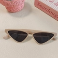 Macro shot of cream cat-eye sunglasses with dark grey lenses on a minimalist background - Pink 12-Cream Cat-eye Style with Dark Lenses