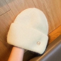 Winter beanie in beige plush knit featuring a golden metal M badge on the side - M-Logo Thickened Style / Off White