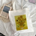 White canvas tote bag featuring Van Gogh Sunflowers painting print on a bed setting - Van Gogh Sunflowers