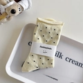 Beige cotton crew socks with black polka dots and rolled cuff design in a cozy setup - One Size / Milky Yellow
