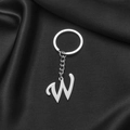 Polished silver stainless steel letter W keychain on elegant black silk background - Letter W