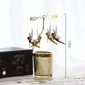 Golden rotating candle holder with fairy pendants and silver flecked glass base - Magic Fairy-E