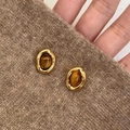 Detailed view of vintage gold-plated oval stud earrings with polished brown tiger eye stone - French Retro Gold Oval Tiger Eye Stud Earrings