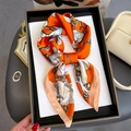 Detailed view of silk scarf featuring magnolia floral patterns in a black gift box - 70x70cm / Orange (FJ814-3)