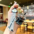 Bubble tea keychain featuring a miniature cup with black pearls and sweet heart strap - Cloud Strap Black Luminous Dried Flower Cup