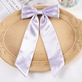 Lavender satin bow hair clip with long ribbons on a decorative display tray - Duckbill Hair Clips / Purple