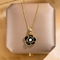 Elegant gold chain necklace with black camellia flower pendant and central white pearl - Gold Black Pearl Camellia