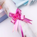 Close-up of rose pink gift pull bow with double gold stripes for festive packaging - Rose Red Gold Edge