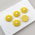 Detailed view of yellow resin flower charms with textured petals and flat backs - Yellow