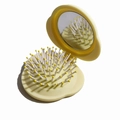 Portable pale yellow folding hairbrush with integrated mirror for compact travel use - Yellow Cloud Folding Hairbrush