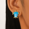 French vintage style golden turtle stud earrings with blue gemstone on model ear - Blue Turtle (Z-055)