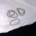 Detailed macro view of five-piece sparkling silver textured stackable rings set - US 5 / Steel