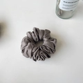 Elegant grey satin oversized scrunchie with French ruffles and silky texture on white surface - Dark Gray