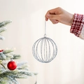 Hand holding a silver glitter hollow spherical Christmas tree hanging ornament - 10cm Silver Christmas Ball