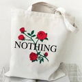Beige canvas tote bag featuring red rose floral print and 'NOTHING' text detail - Red Rose Nothing (Cream)