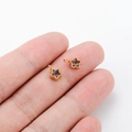 Star-shaped golden stainless steel pendants with purple zircon inlays on fingertip - Purple Zirconia Star