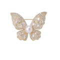 Elegant gold butterfly brooch with shimmering crystals and a central white pearl detail - Gold Plated Copper Shell Pearl Butterfly