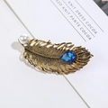 Antique gold feather brooch with white pearl and blue teardrop gemstone detail - Antique Gold Feather + Blue Glass