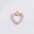 Detailed macro view of heart-shaped rose gold pendant with sparkling white cubic zirconia - Rose Gold Hollow Heart Pendant